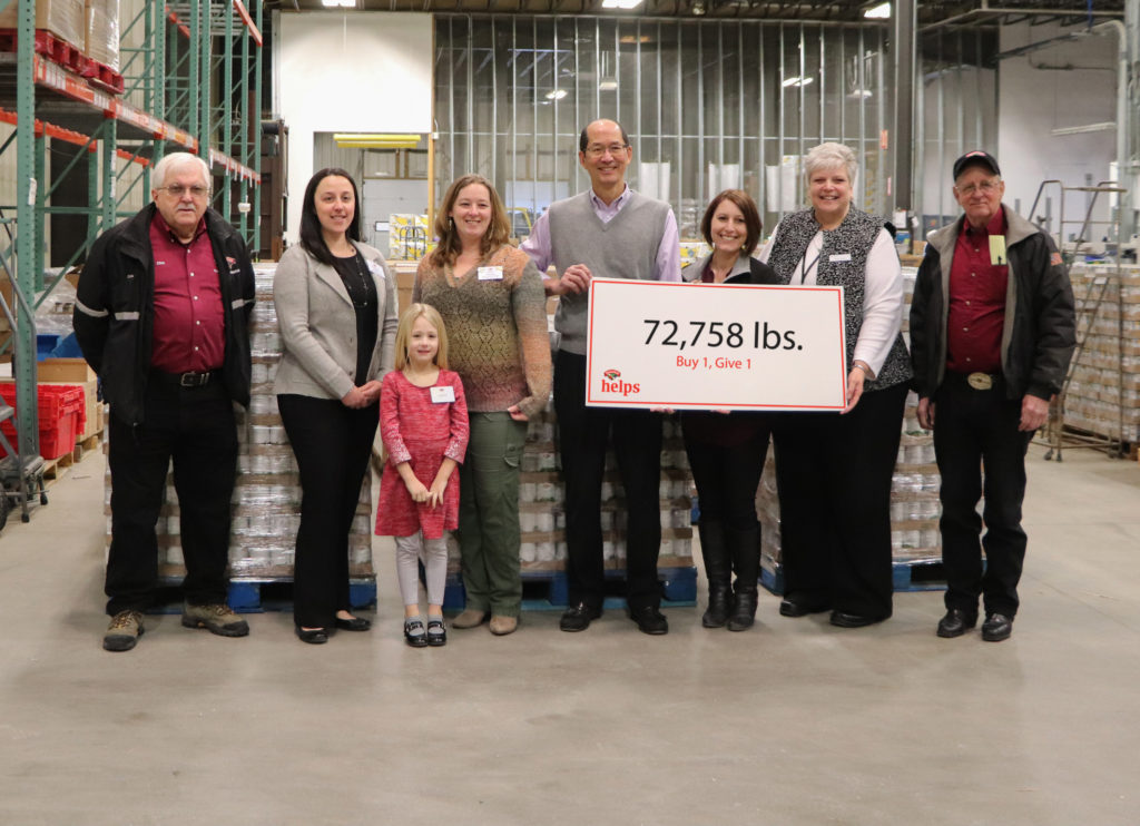 Hannaford Helps Fight Hunger presents a sign for 72,758 pounds generated for Good Shepherd Food Bank.