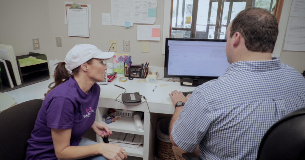 Man and lady at a computer desk