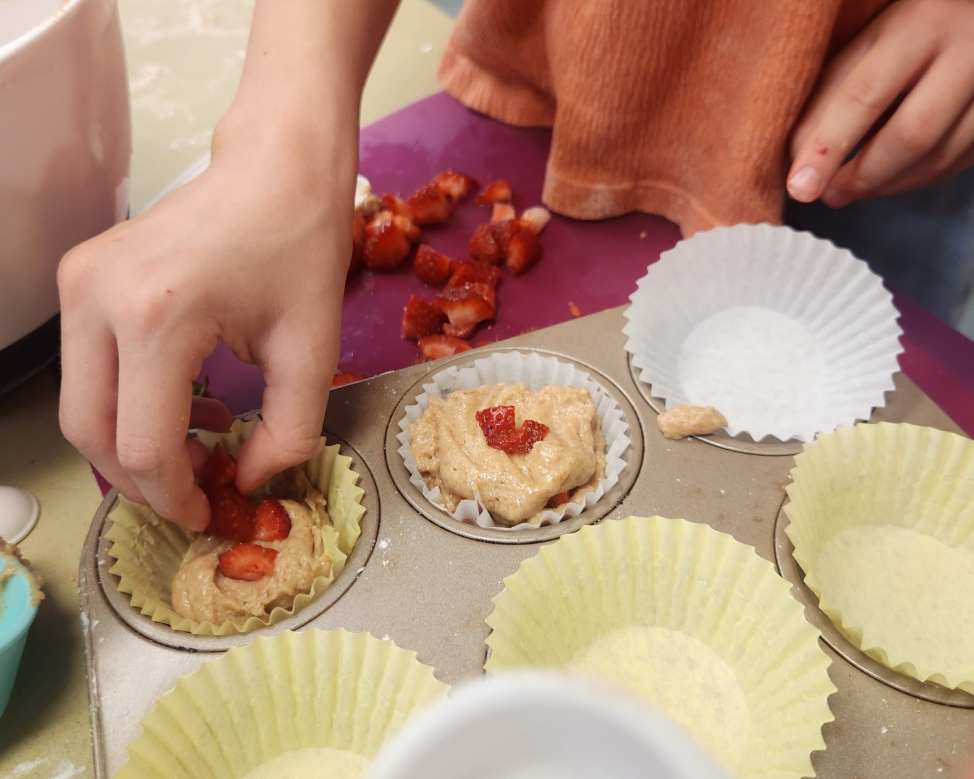 Child baking muffins.