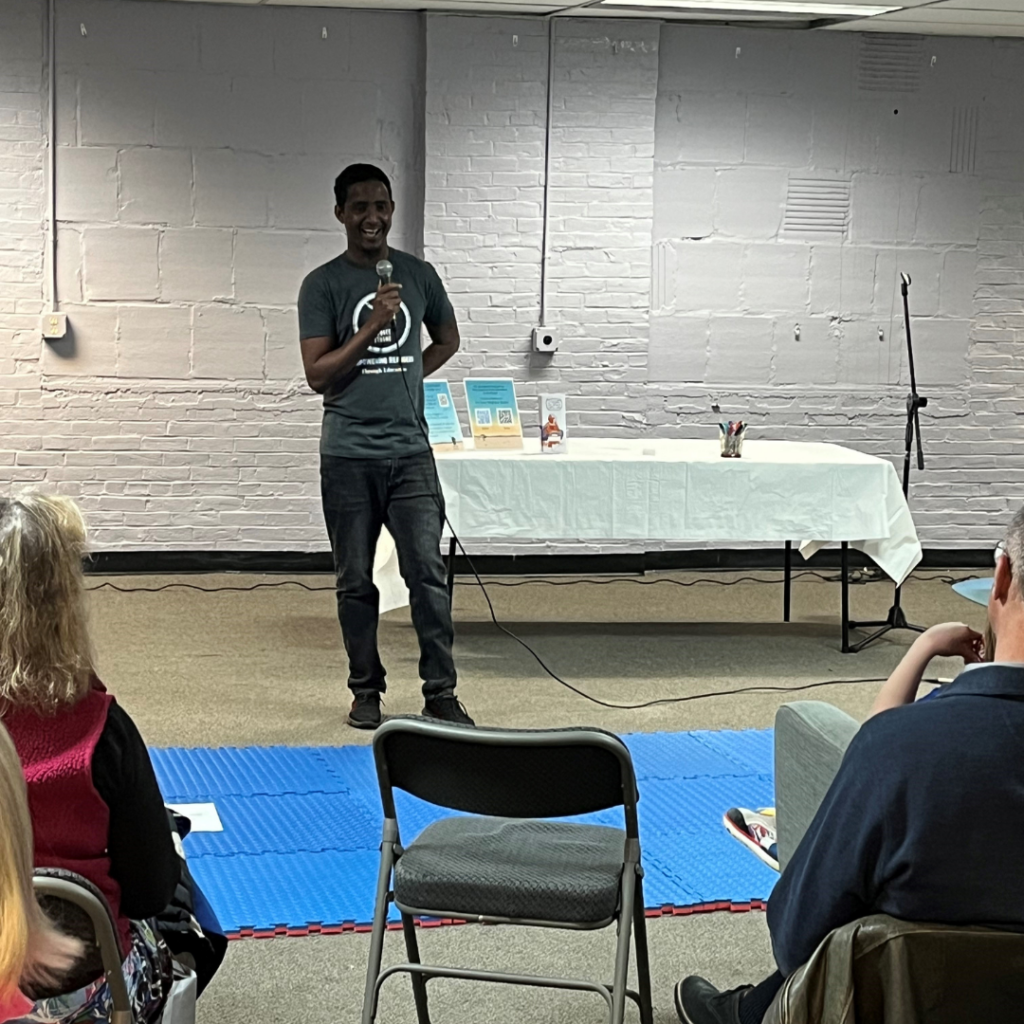 Man standing doing presentation at cultural celebration