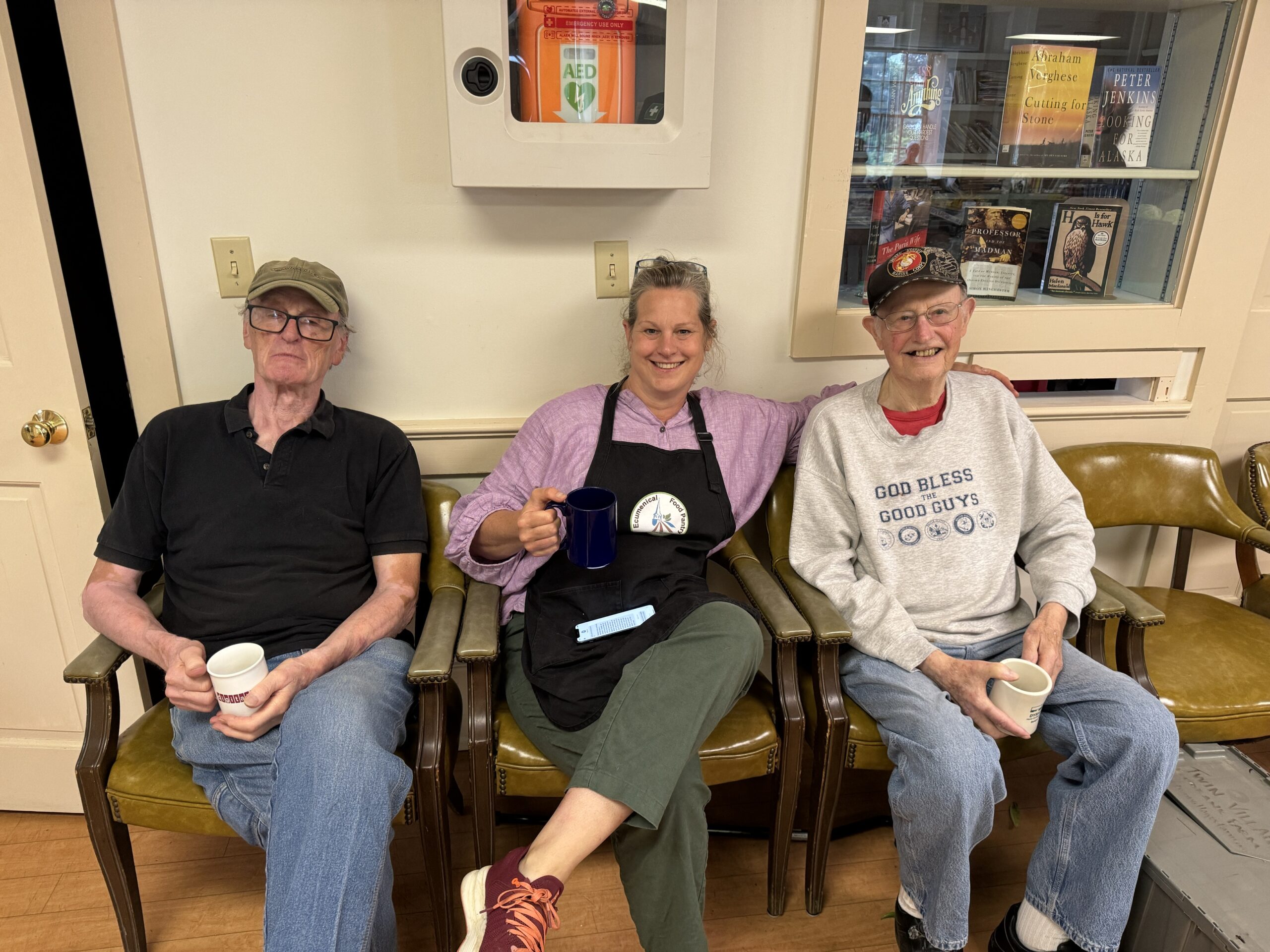 Three volunteers at a food pantry