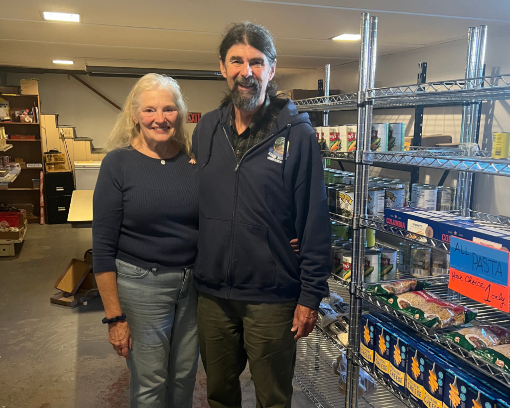 Two volunteers in a food pantry.