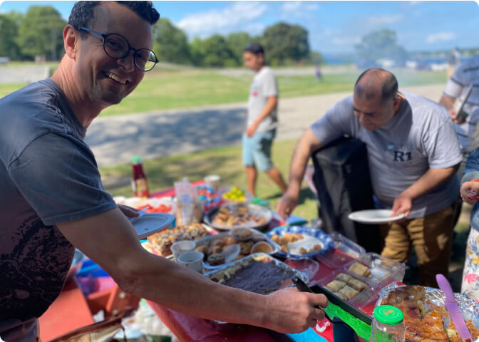 Good Shepherd Food Bank team members eating at a barbecue